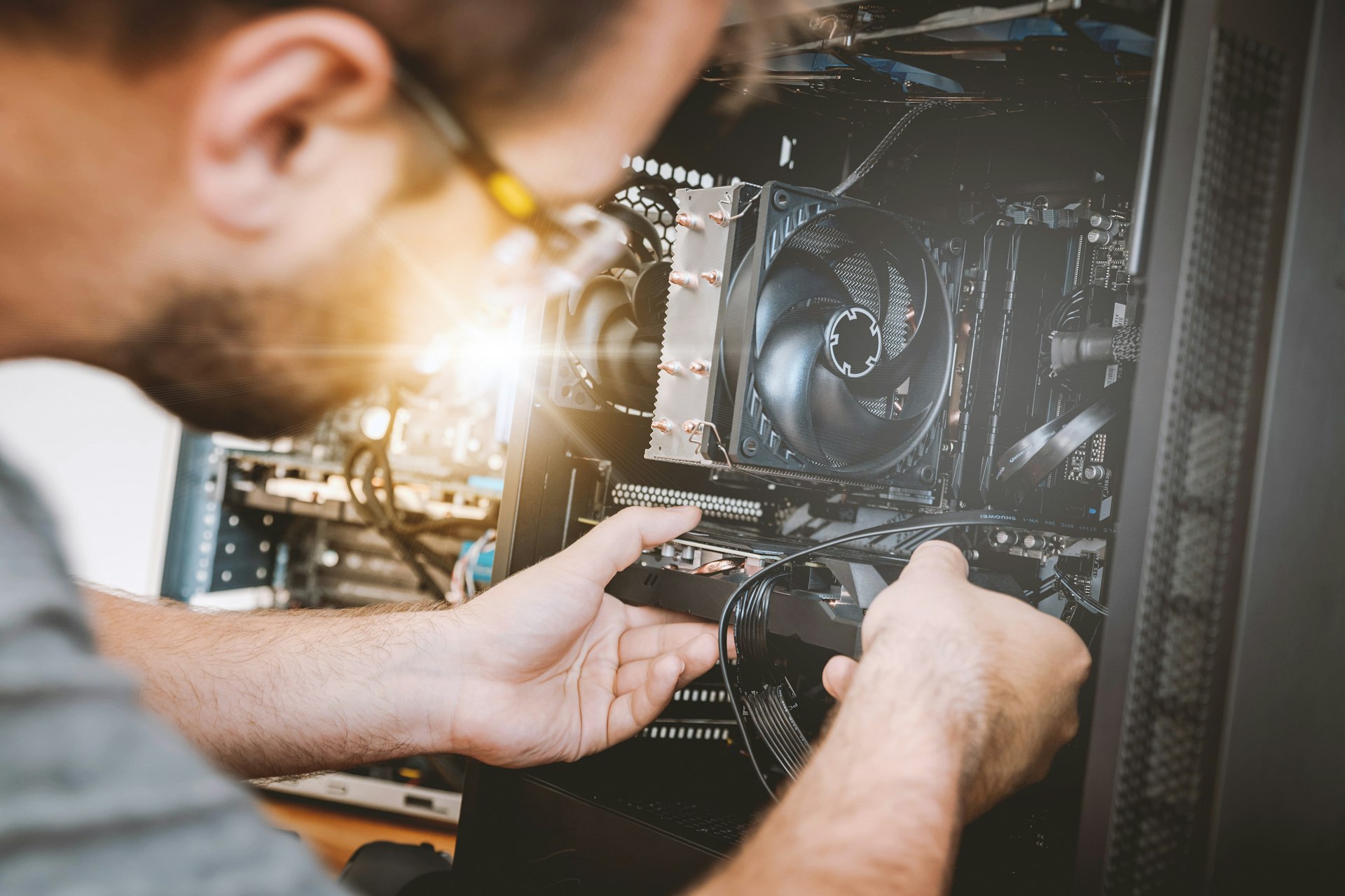 Computer repair technician working on motherboard in Warner AB